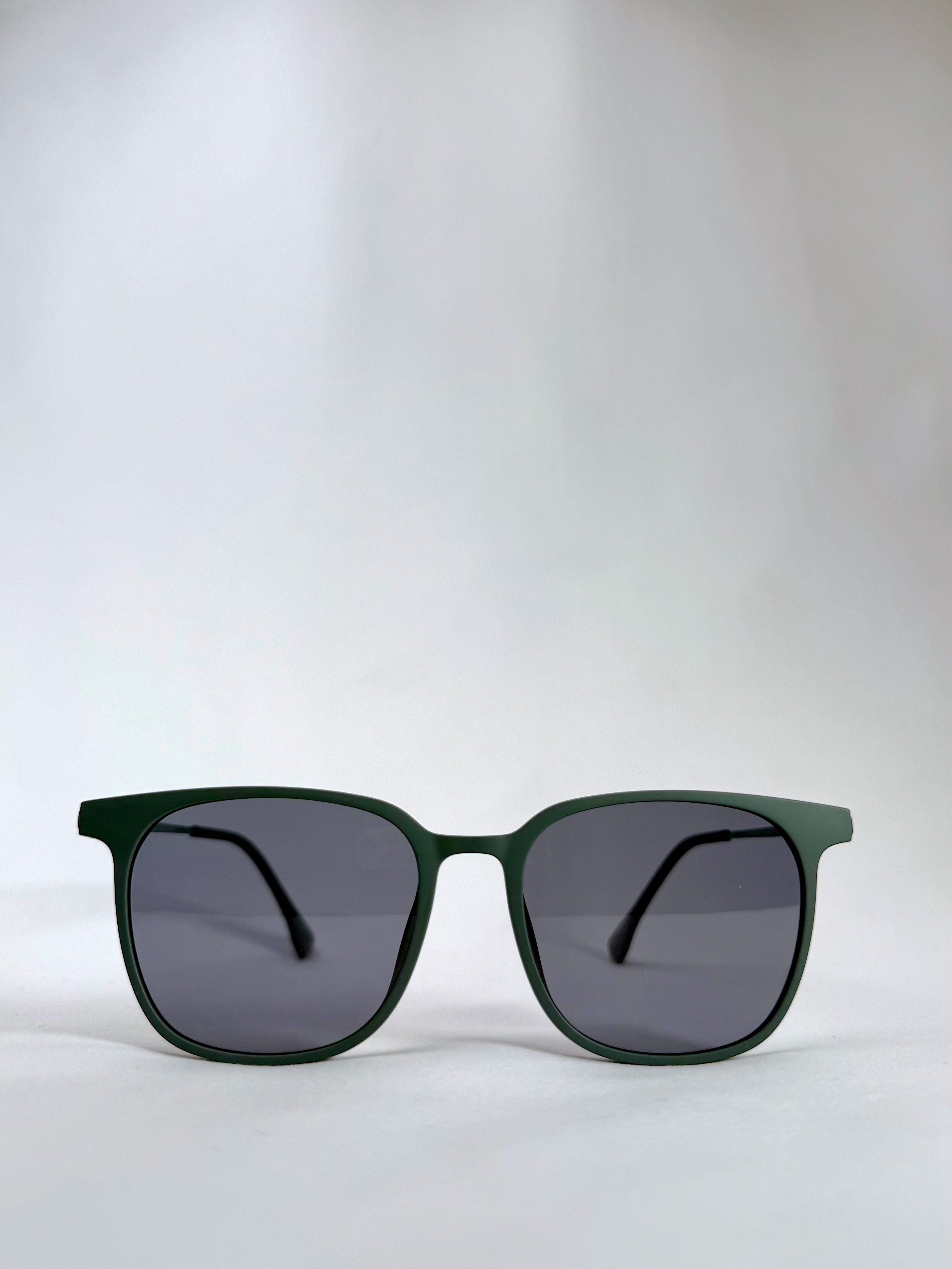 Front view of Achernar deep matte green titanium sunglasses with UV400 polarized lenses, offering a modern and refined look.
