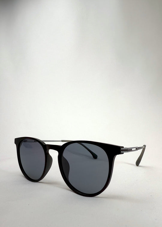 Angled shot of Altair matte black sunglasses highlighting its sleek, modern design.