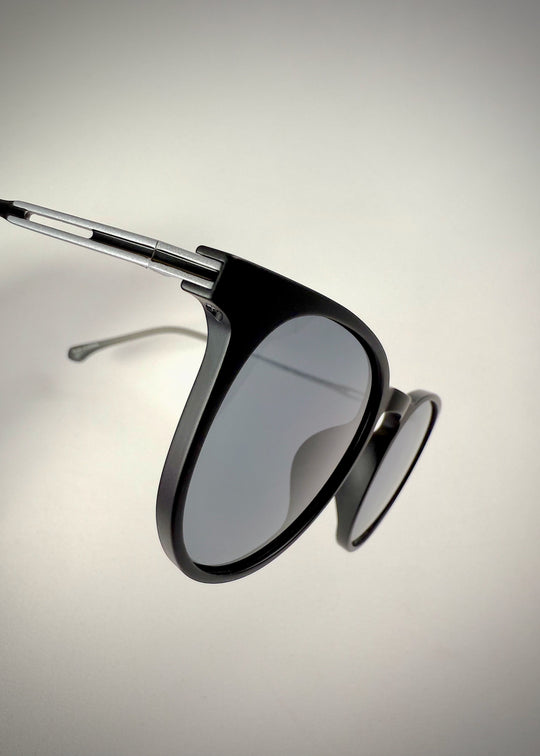 Close-up of Altair matte black titanium sunglasses' frame and arm details.