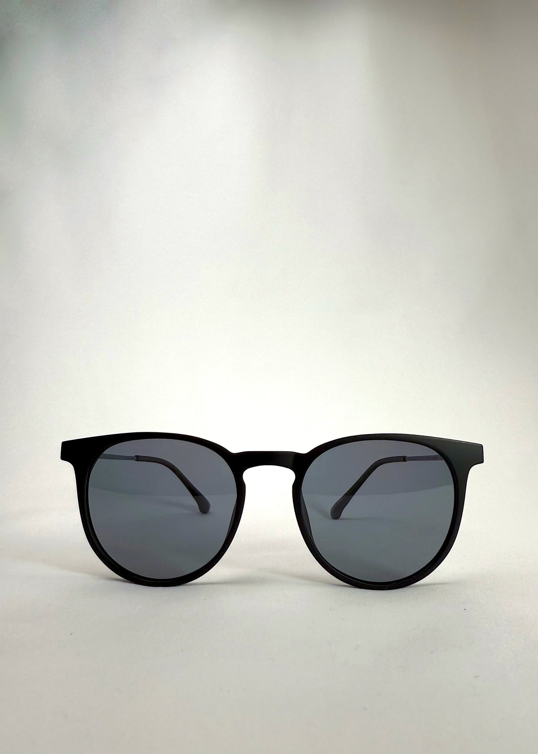 Front view of Altair matte black titanium prescription sunglasses with UV400 polarized lenses.