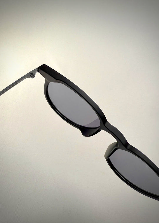 Detailed close-up of Altair matte black sunglasses' fixed nose pads and arm.