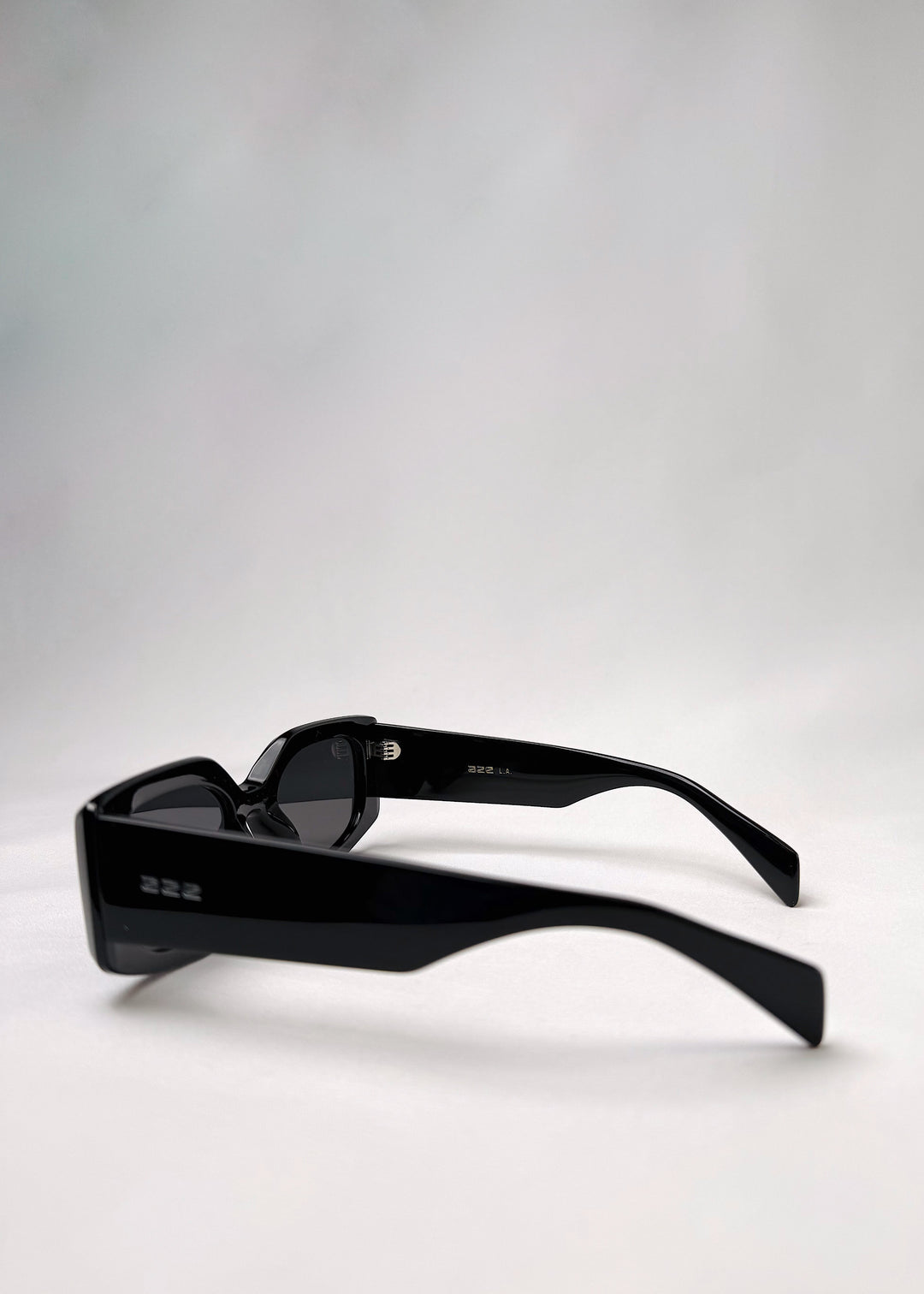 Side view of Bellatrix black acetate sunglasses showcasing the bold frame and smooth design.