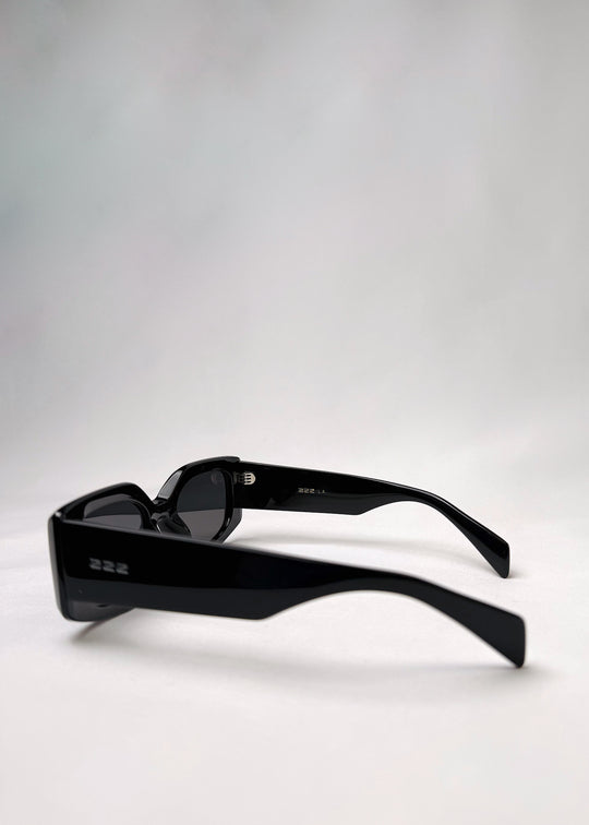Side view of Bellatrix black acetate sunglasses showcasing the bold frame and smooth design.