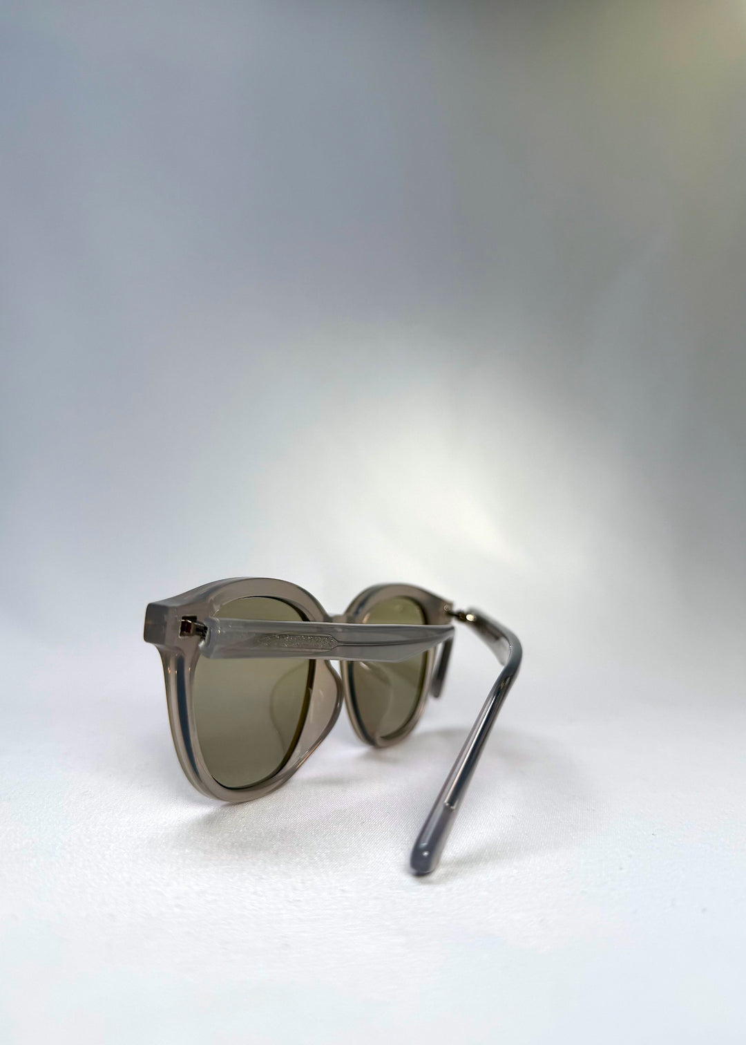 Back angle view of Elvor sunglasses in Glacier Smoke, showing lightweight temple arms and clear silhouette.