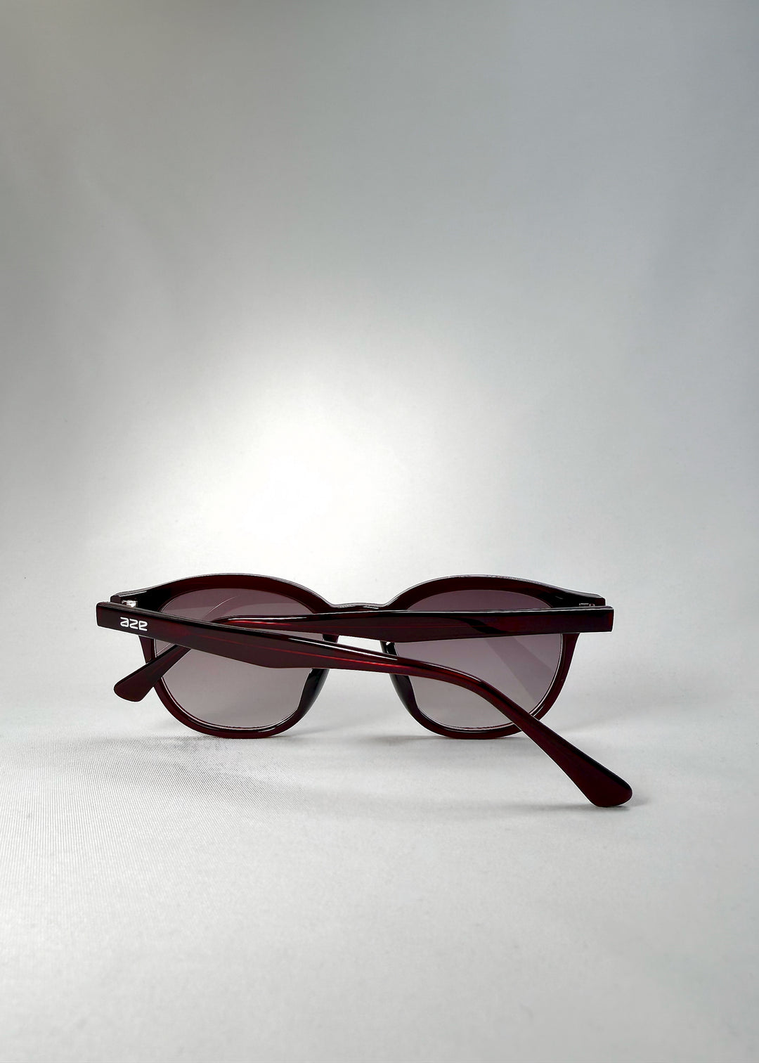 Back angle view of Elvor sunglasses in Mulberry Mist, showcasing the curvature of the frame and tinted lenses from above.