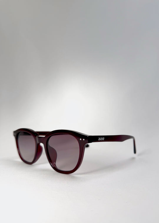Front angle view of Elvor sunglasses in Mulberry Mist, showing soft violet-to-grey gradient lenses and a rounded frame silhouette.