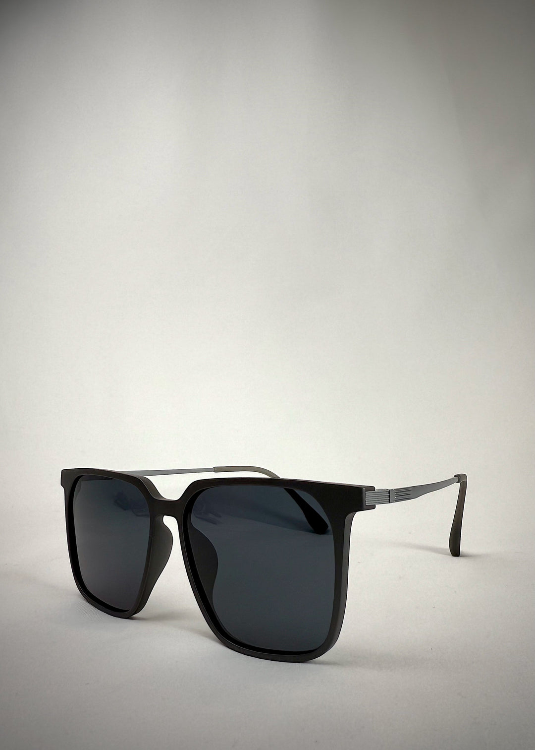 Angled view of Gemini Matte Gray sunglasses, highlighting the sharp contours and lightweight titanium frame.