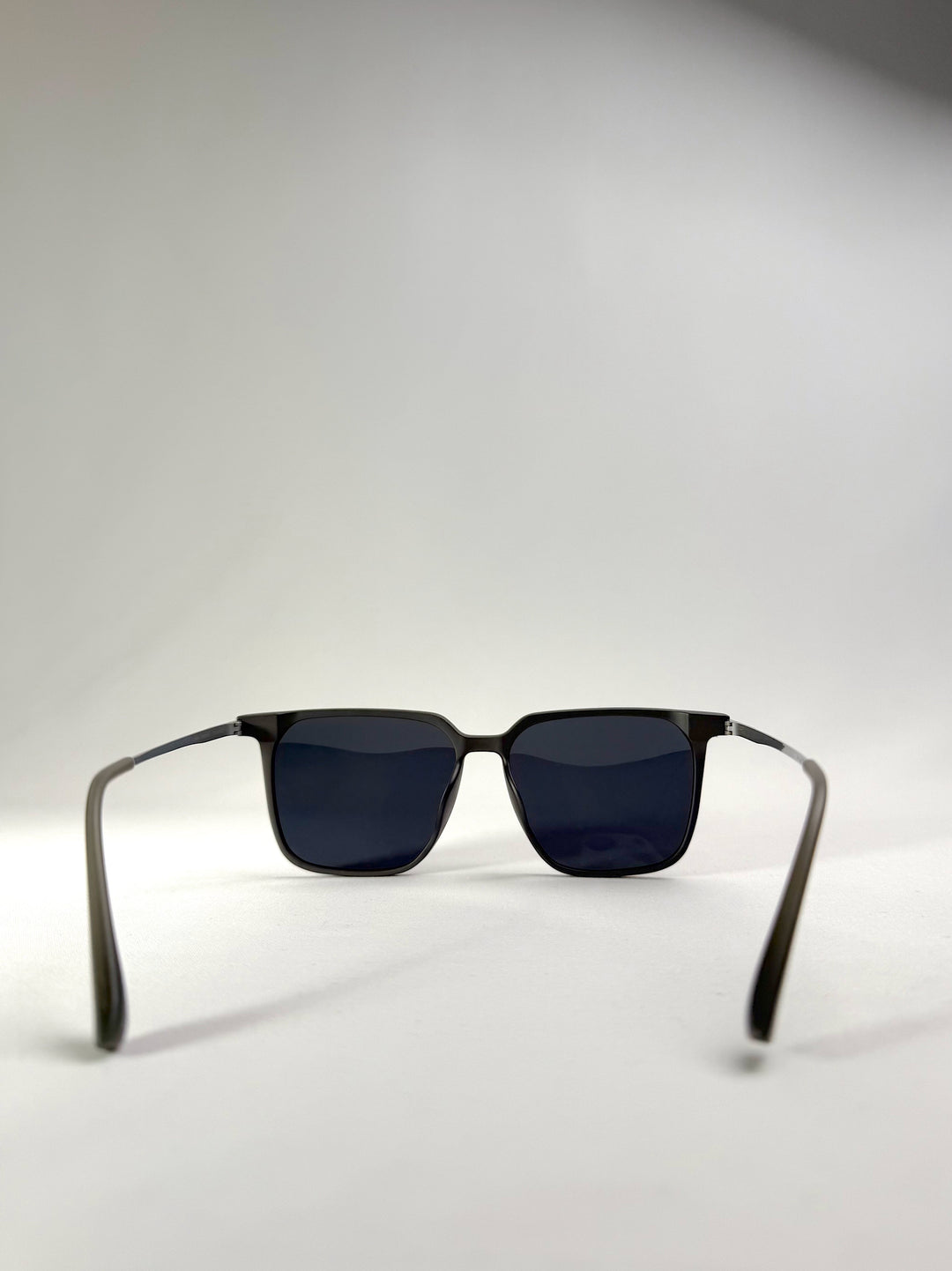 Back view of Gemini Matte Gray titanium prescription sunglasses, showcasing the ultra-lightweight frame and sleek temple design for a modern and refined look.