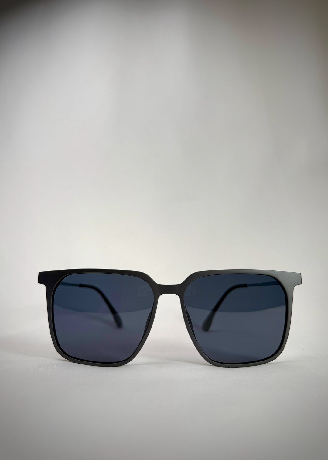 Front view of Gemini Matte Gray titanium sunglasses, showcasing the sleek square frame and modern matte finish.