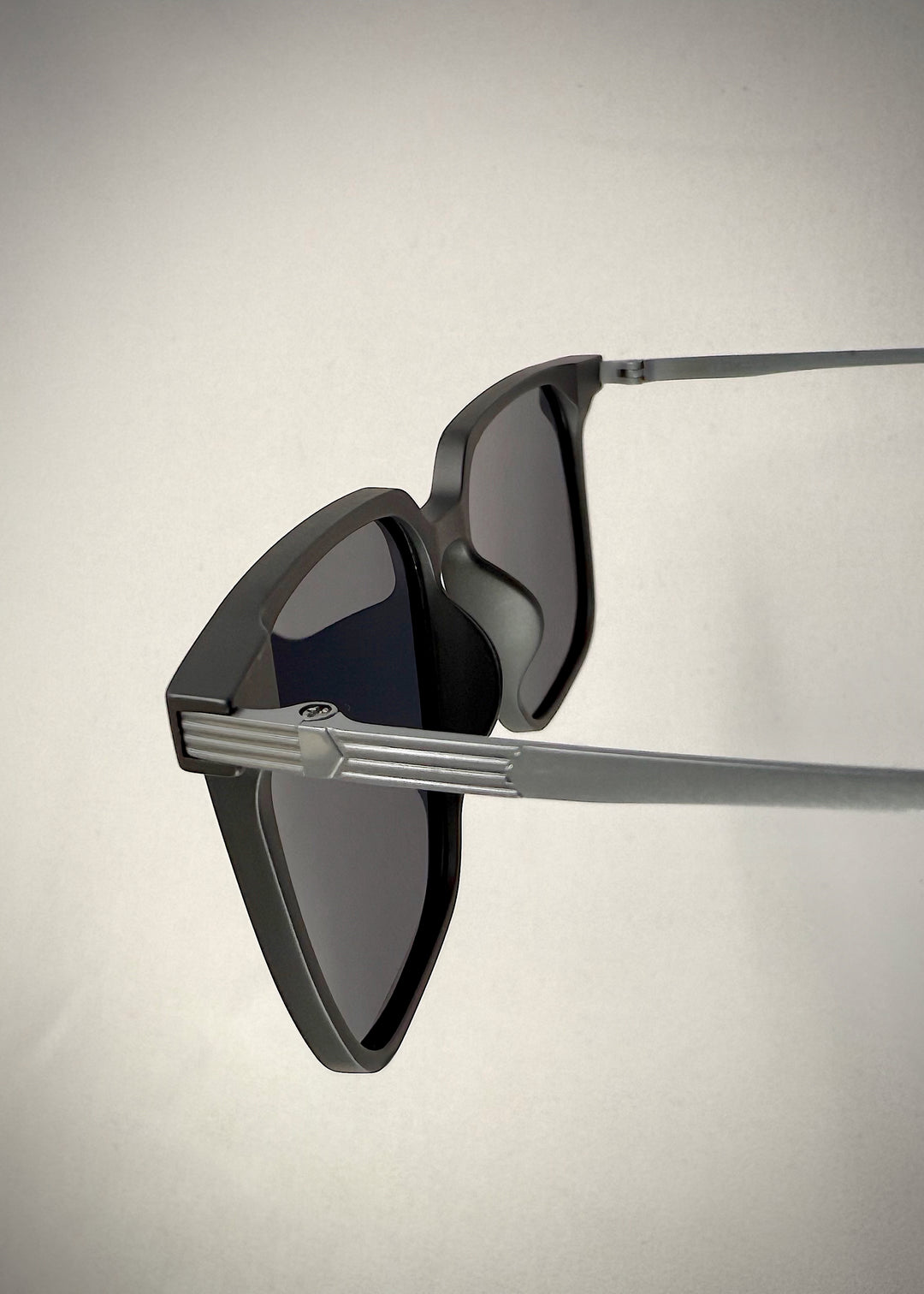 Close-up of Gemini Matte Gray titanium sunglasses’ temple, displaying the premium material and minimalist design.