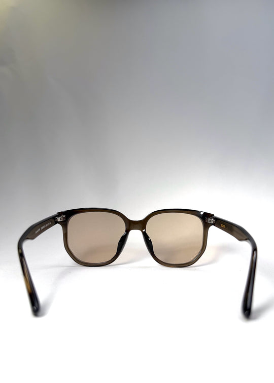 Back view of Lucent Rift sunglasses in Sepia Veil, highlighting the soft beige-brown lenses and sculpted translucent frame.