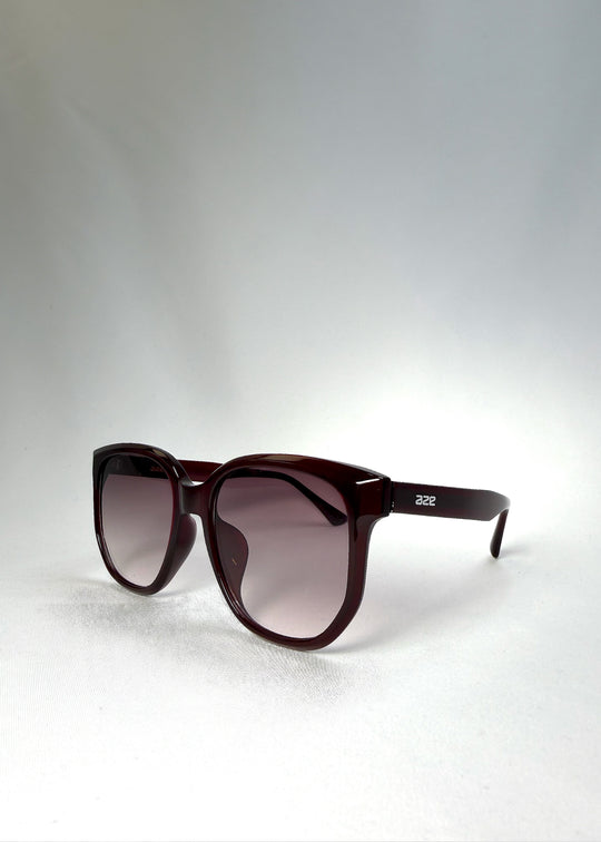 Angled front view of Lucent Rift in Velvet Eclipse highlighting the floating brow line and plum-tinted gradient lenses.