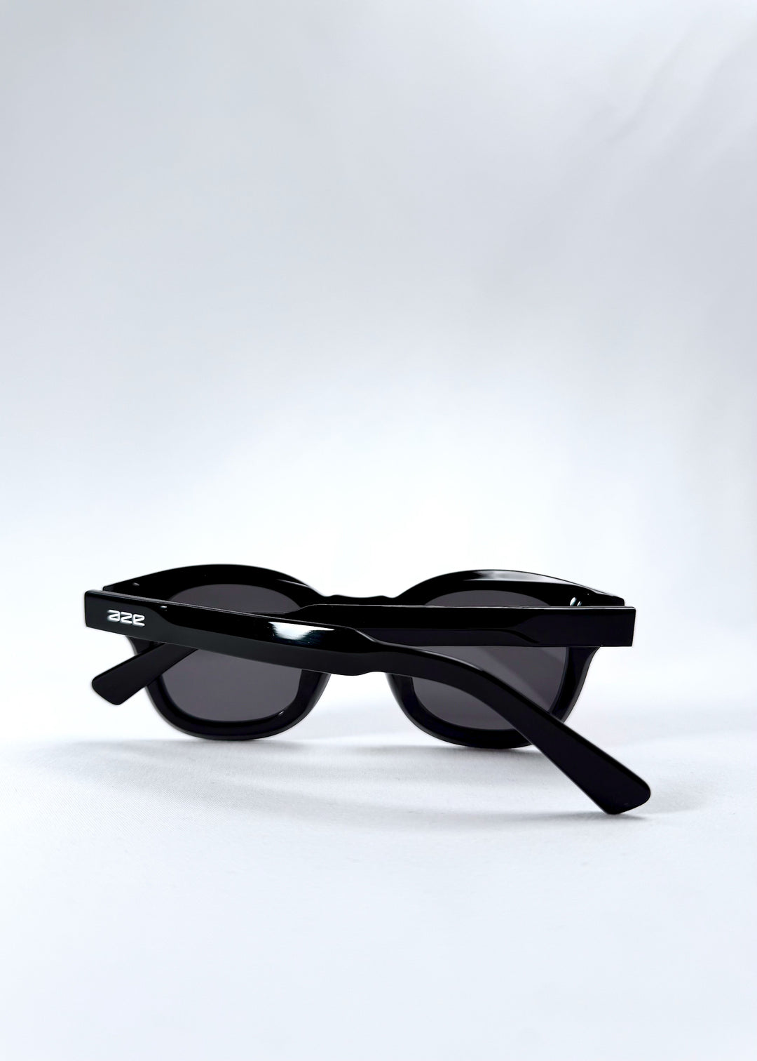 Folded view of Phantom Verge sunglasses in Obsidian Black, emphasizing portability and frame thickness.