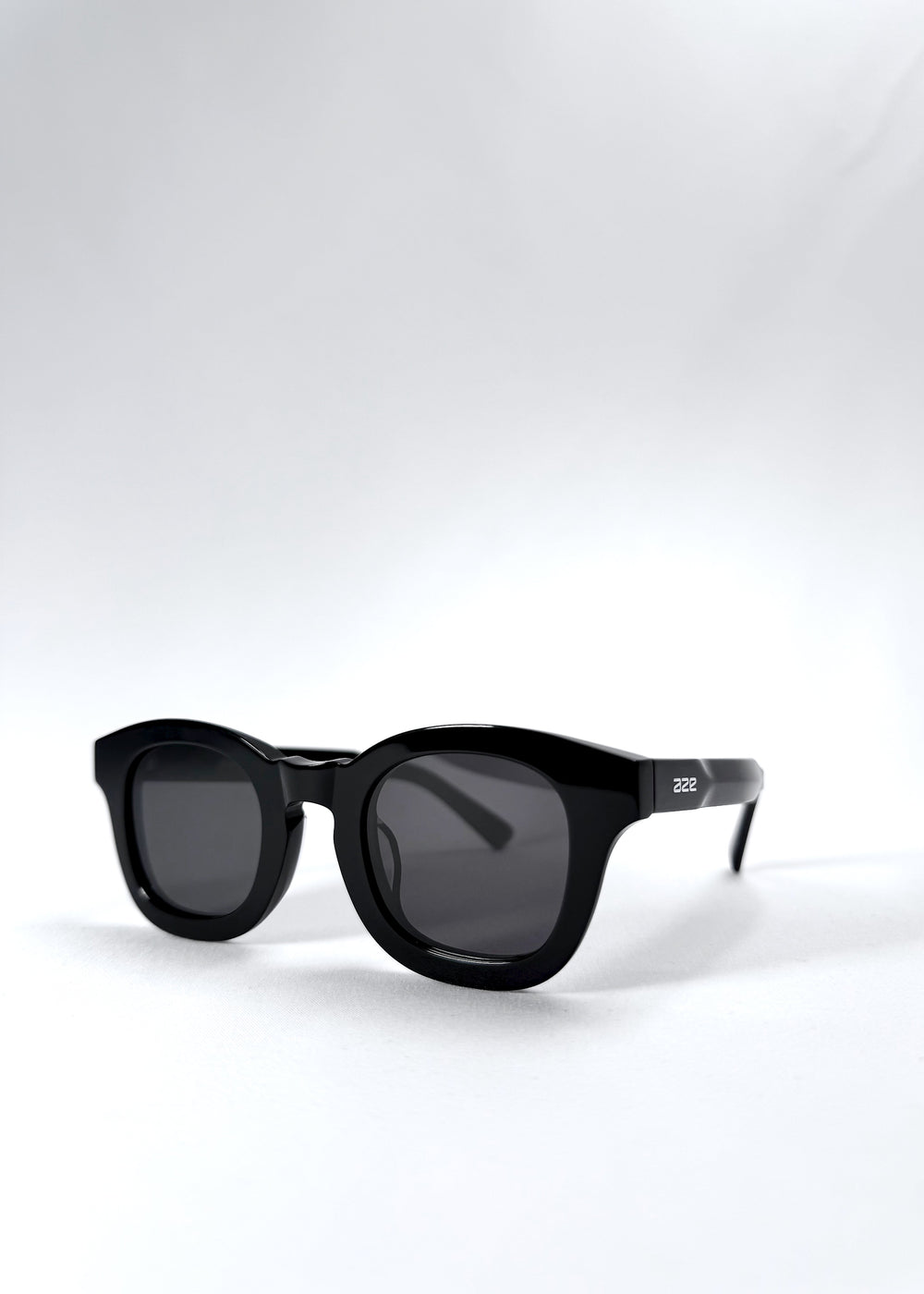 Front angle view of Phantom Verge sunglasses highlighting the sculptural black acetate frame and round lens shape.