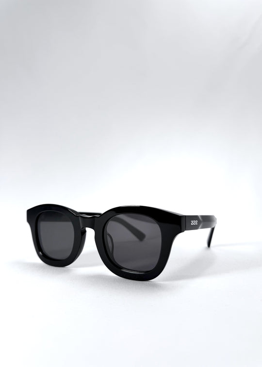 Front angle view of Phantom Verge sunglasses highlighting the sculptural black acetate frame and round lens shape.