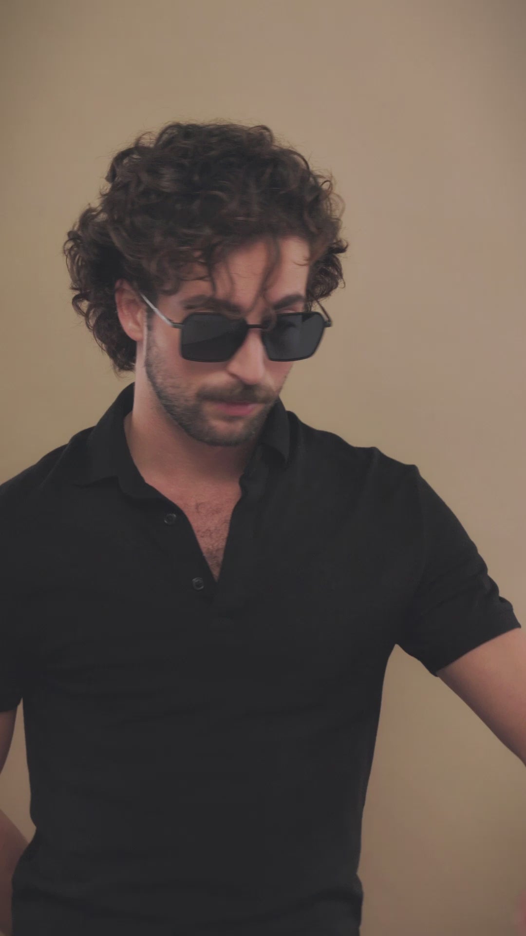 Video of a male model wearing Rigel matte blue titanium sunglasses, showcasing the modern design and bold aesthetic.
