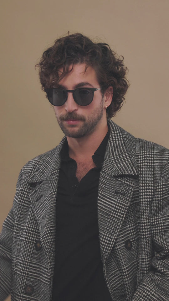 Video of male model wearing Altair matte black titanium prescription sunglasses, highlighting its sleek frame and lightweight feel.