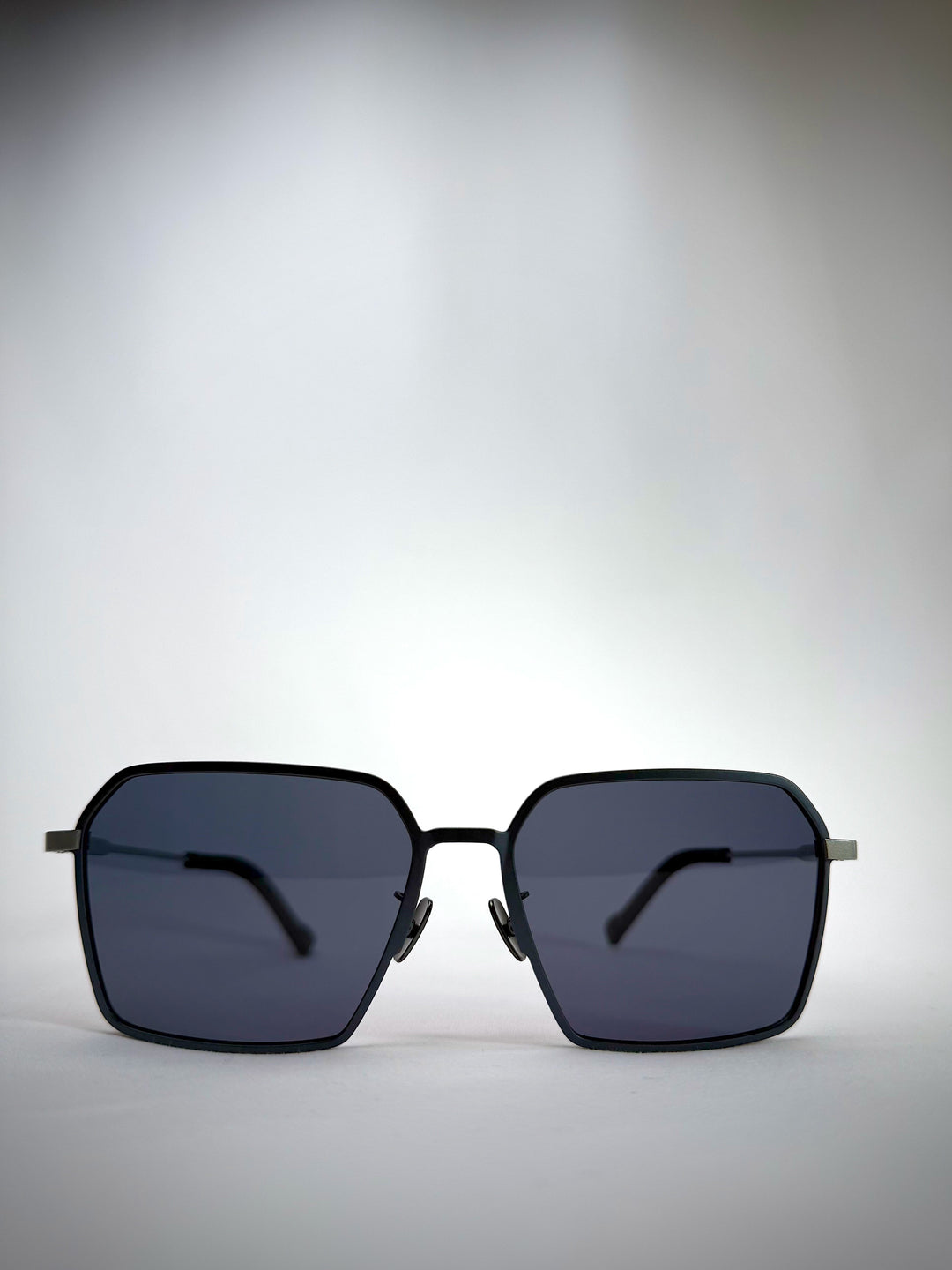 Front view of Rigel matte blue titanium sunglasses featuring a bold geometric frame and polarized lenses.