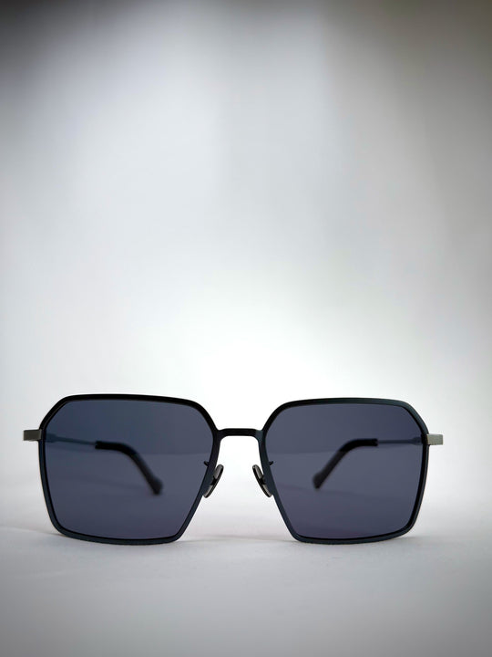 Front view of Rigel matte blue titanium sunglasses featuring a bold geometric frame and polarized lenses.