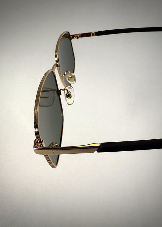 Close-up of Sirius A - Gold sunglasses hinge, highlighting the precision engineering and stainless steel craftsmanship.