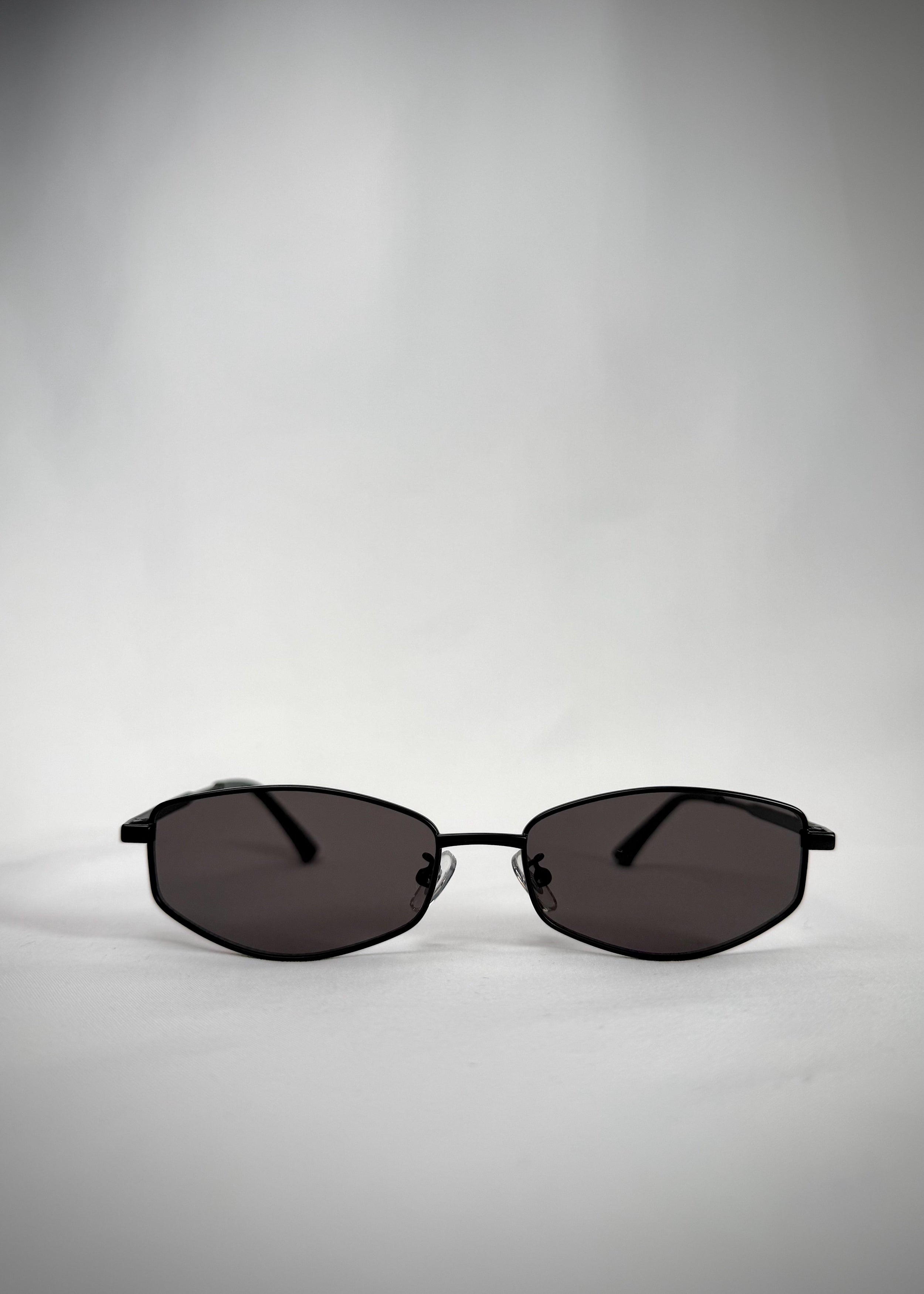 Front view of Sirius B - Matte Black stainless steel sunglasses, showcasing its sleek oval frame and neutral gray lenses.