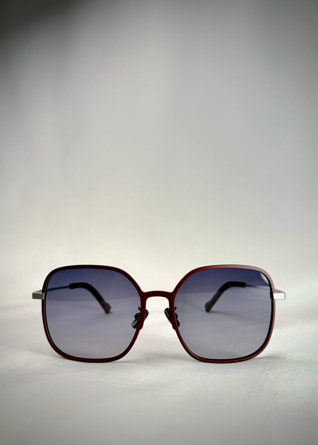 Front view of Spica cherry red titanium sunglasses – a bold yet elegant frame for modern sophistication.