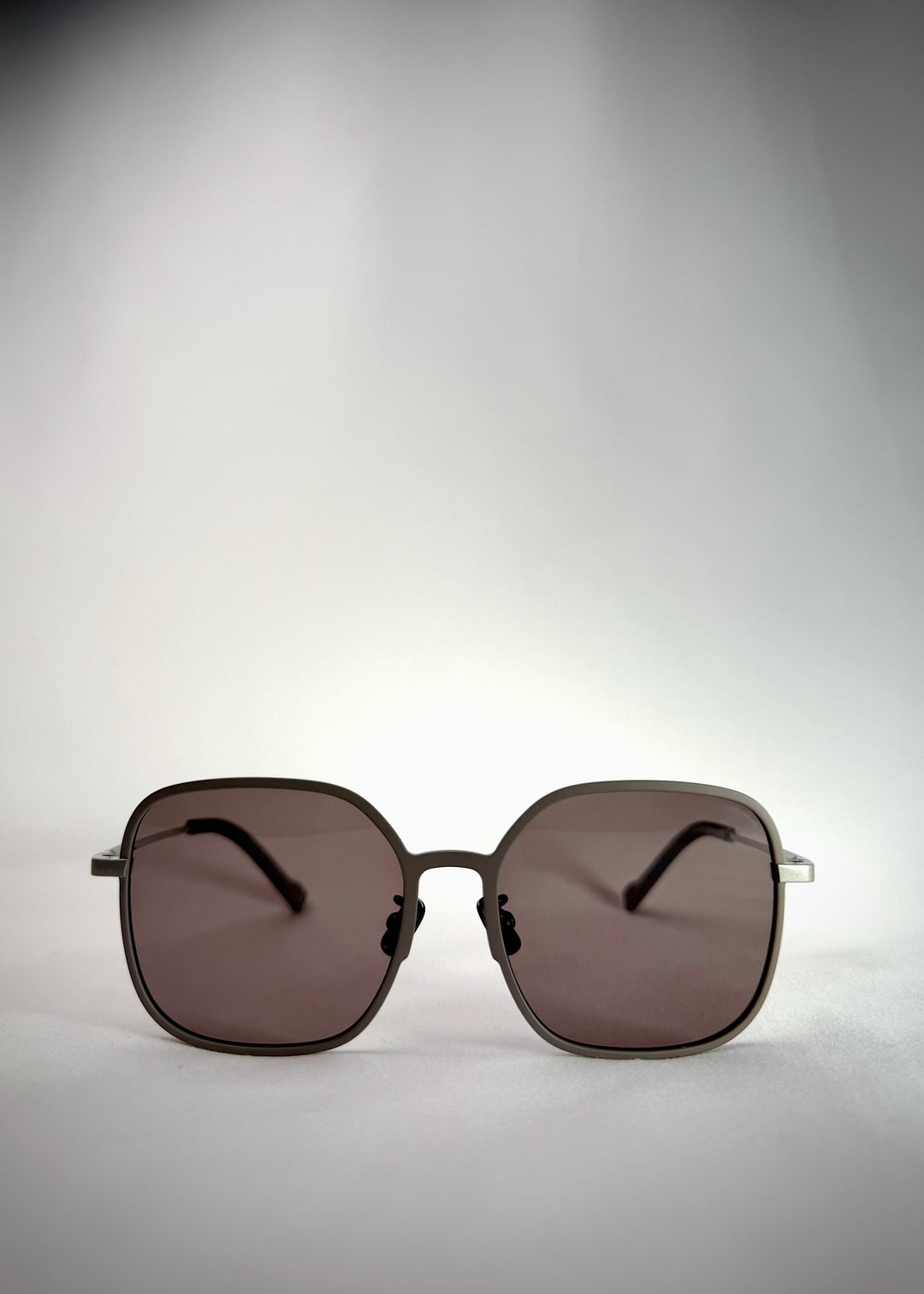 Front view of Spica Milk Tea Brown titanium frame - Elegant prescription sunglasses with warm brown tones.