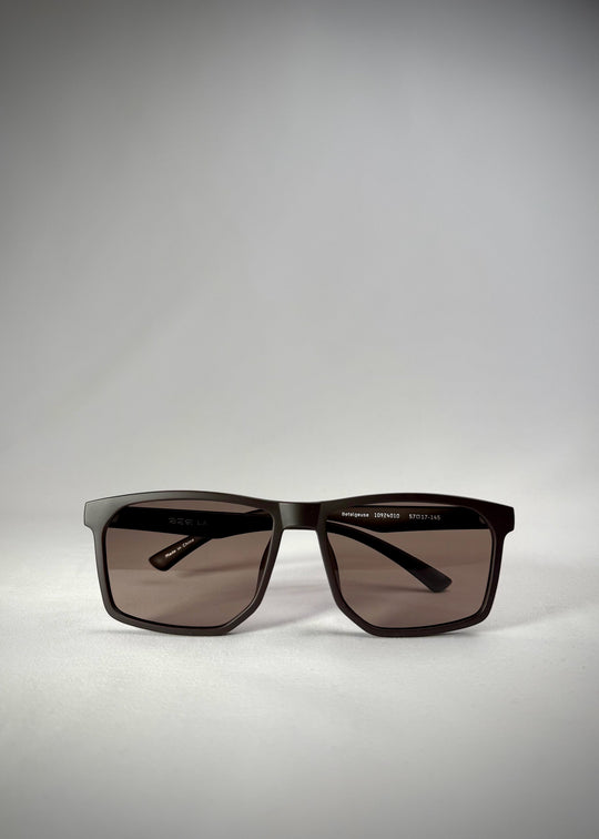 Low front view of Betelgeuse matte brown TR90 sunglasses, showing the rectangular frame and warm brown gradient lenses. 