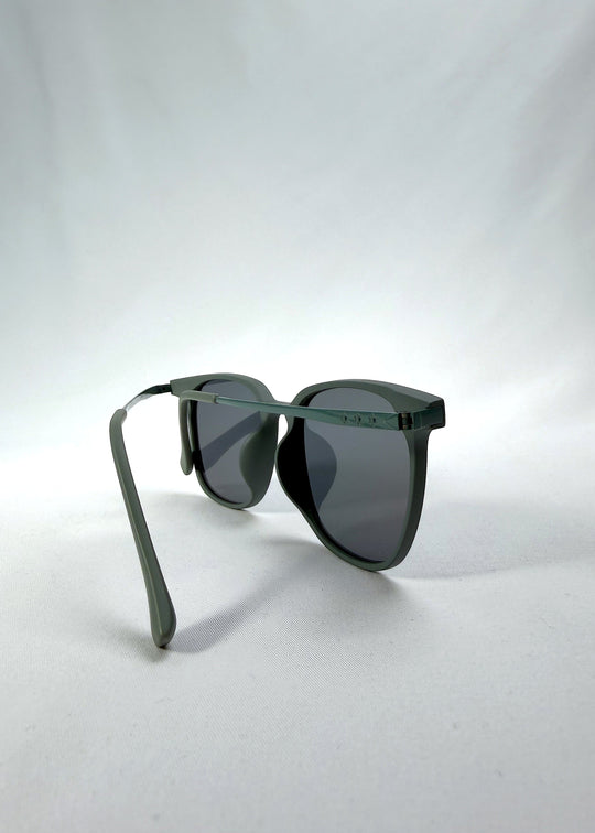 Back-angle view of Achernar sunglasses in Deep Matte Green, featuring an ultra-light frame with titanium temples, softly geometric lens shape, and polarized lenses, showing the back structure and temple alignment. 