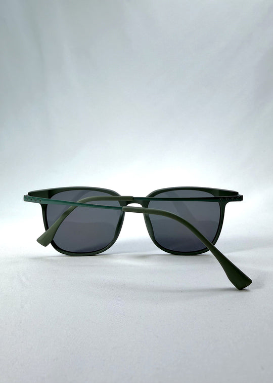 Folded view of Achernar sunglasses in Deep Matte Green, featuring an ultra-light frame with titanium temples, softly geometric lens shape, and polarized lenses, showing the folded temples and frame profile. 