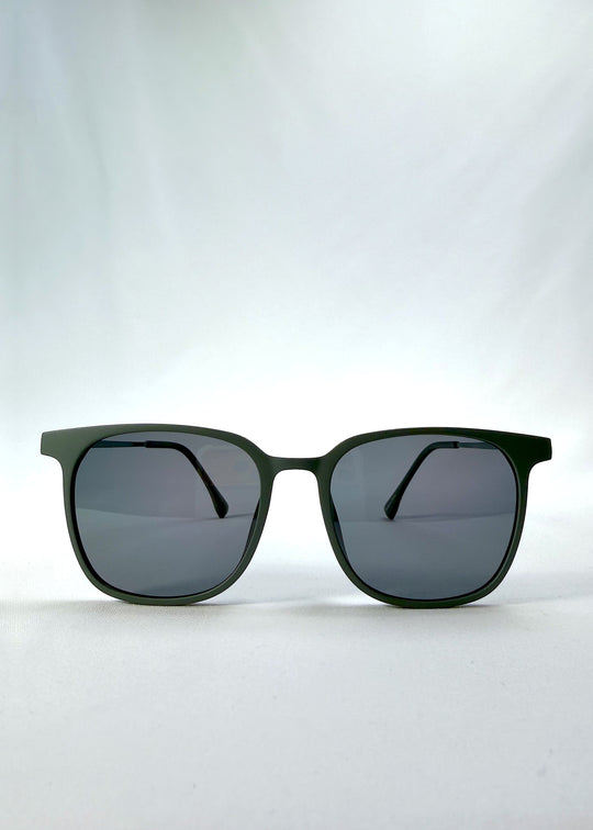 Front view of Achernar sunglasses in Deep Matte Green, featuring ultra-light titanium frame, softly geometric lens shape, and polarized lenses, showing the full front silhouette.