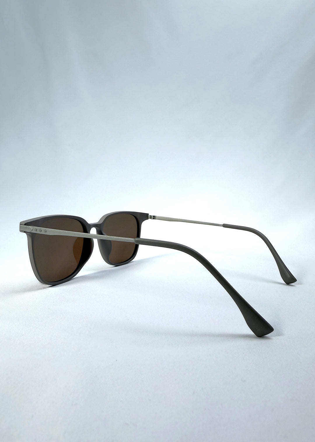Side-angle view of Achernar sunglasses in Khaki Brown, featuring an ultra-light frame with titanium temples, softly geometric lens shape, and polarized lenses, showing the lens shape and temple profile. 