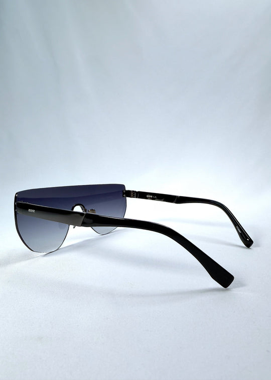 Side view of Aegis Field sunglasses in Gunmetal Veil, featuring one-piece titanium shield frame and gunmetal-to-grey gradient lens, showing the lens shape and temple profile. 