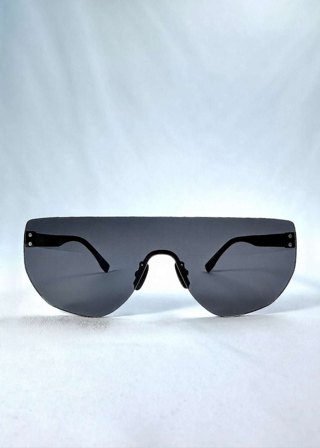 Front view of Aegis Field sunglasses in Mercury Shadow, featuring one-piece titanium shield frame and silver mirrored lens, showing the full front silhouette. 