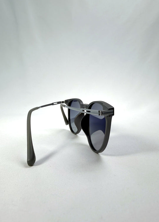 Back-angle view of Altair sunglasses in Matte Gray, featuring a minimal frame with titanium temples, rounded square lens shape, and polarized lenses, showing the back structure and temple alignment. 