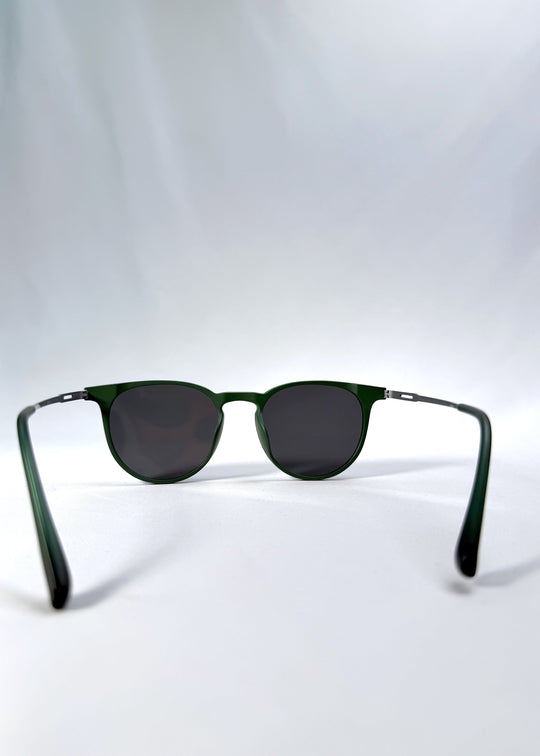 Back view of Altair sunglasses in Matte Green, featuring a minimal frame with titanium temples, rounded square lens shape, and polarized lenses, showing the inside frame and open temples. 