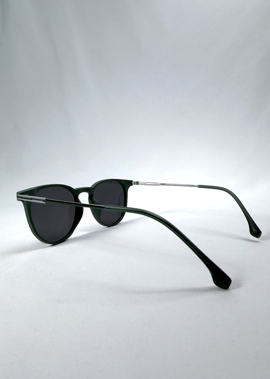 Side-angle view of Altair sunglasses in Matte Green, featuring minimal titanium frame, rounded square lens shape, and polarized lenses, showing the lens shape and temple profile.