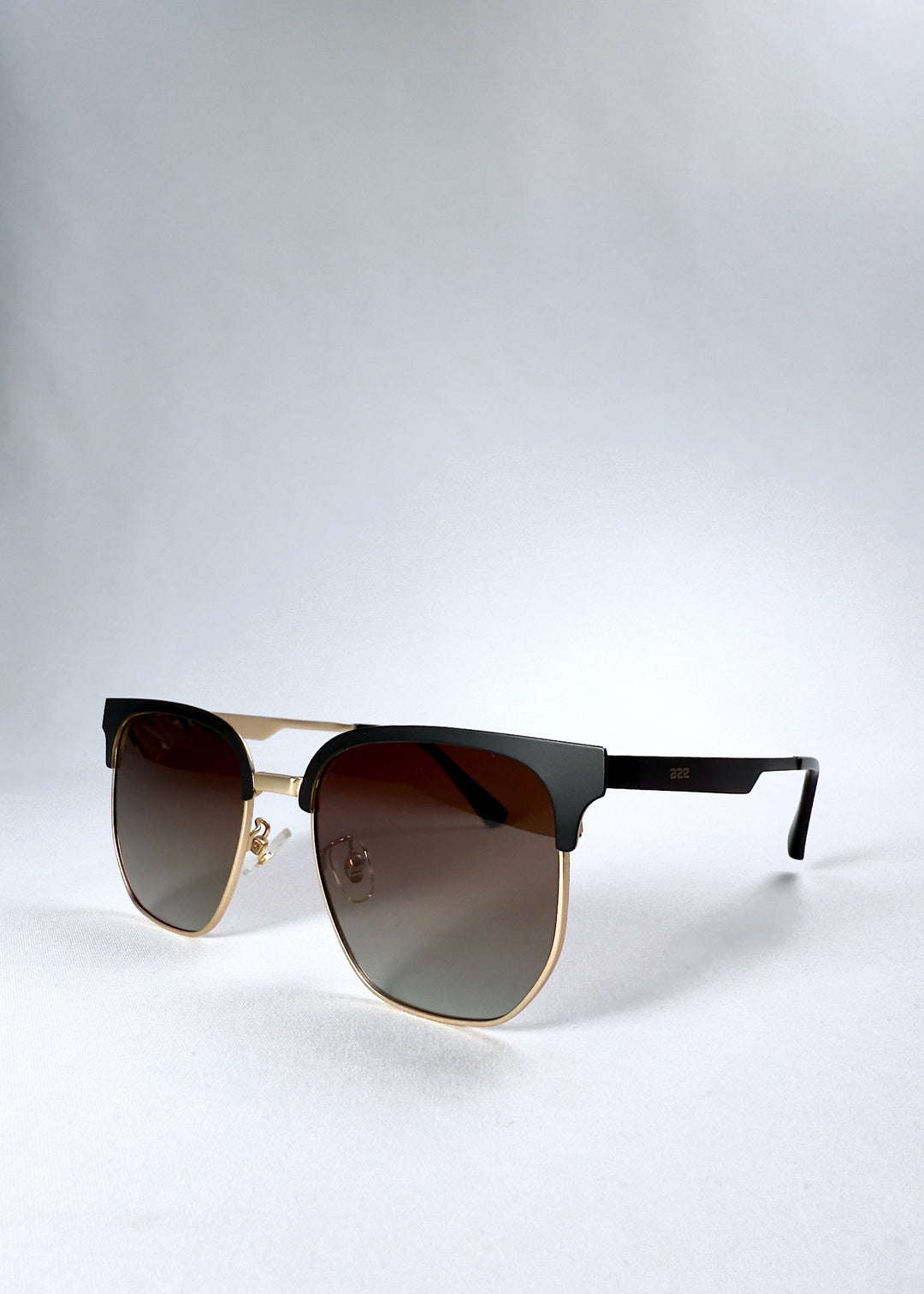 Front angle view of Altessa in Antique Brass showing the black browline detail and warm brass rims. 