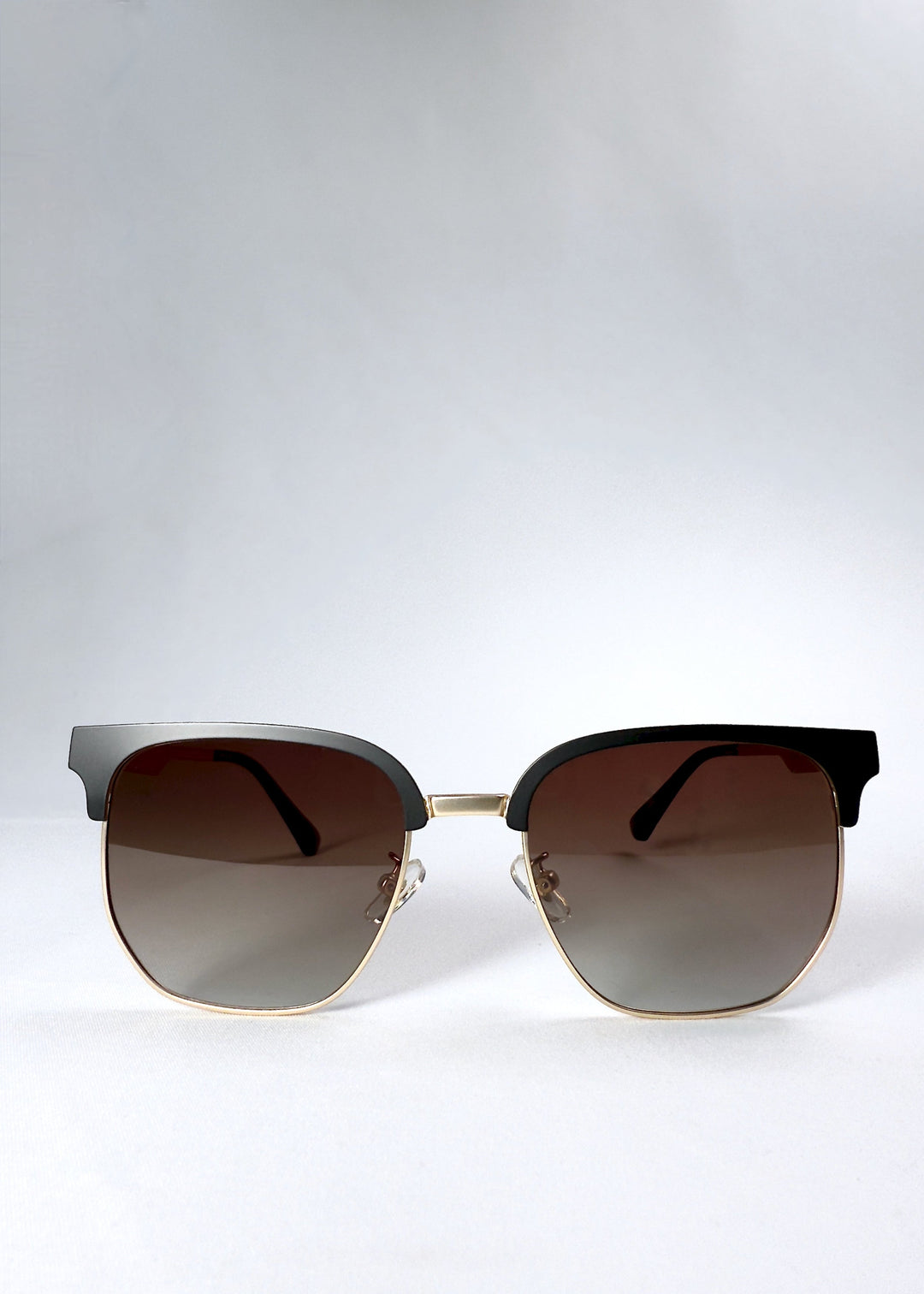 Front view of Altessa sunglasses in Antique Brass with gradient brown lenses and a semi-rimless browline frame. 