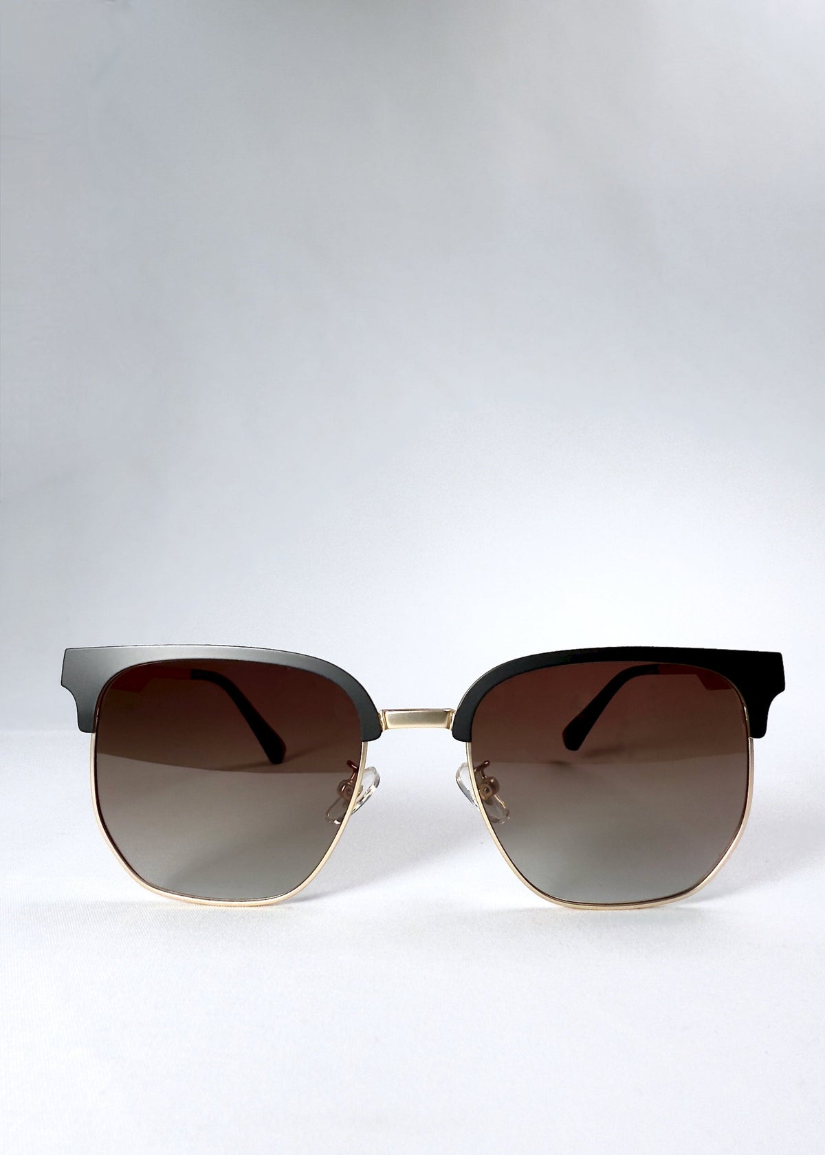 Front view of Altessa sunglasses in Antique Brass with gradient brown lenses and a semi-rimless browline frame.