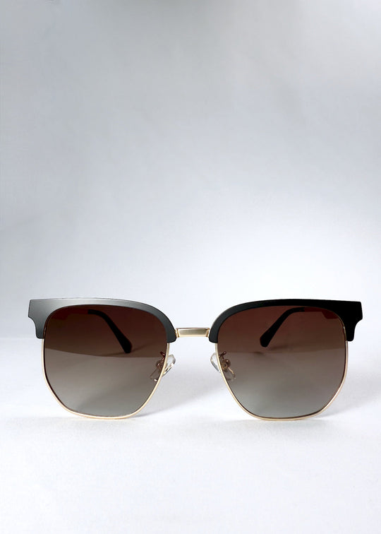 Front view of Altessa sunglasses in Antique Brass with gradient brown lenses and a semi-rimless browline frame. 