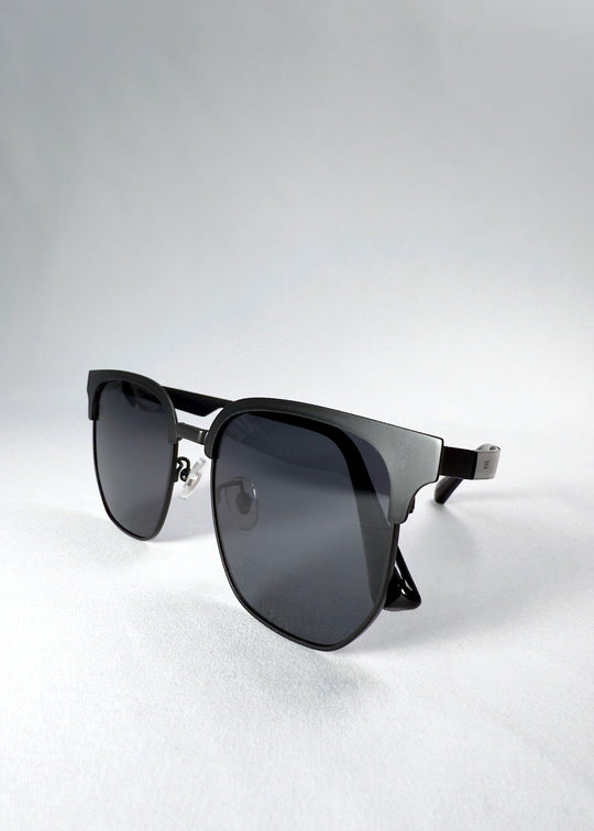 Folded view of Altessa sunglasses in Eclipse Black, emphasizing compact storage and smooth hinge detail.