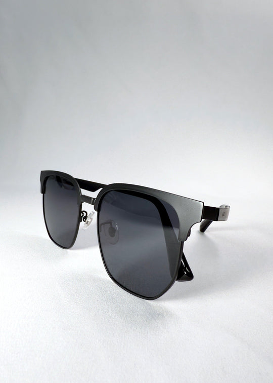 Folded view of Altessa sunglasses in Eclipse Black, emphasizing compact storage and smooth hinge detail. 