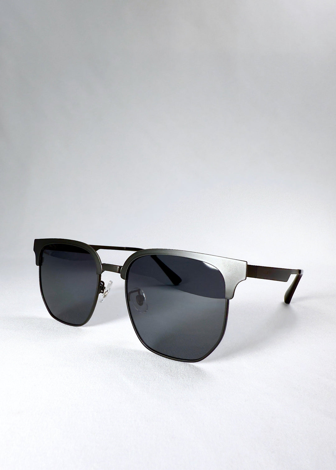 Angled front view of Altessa sunglasses in Eclipse Black, highlighting the matte-black finish and full-coverage grey lenses. 