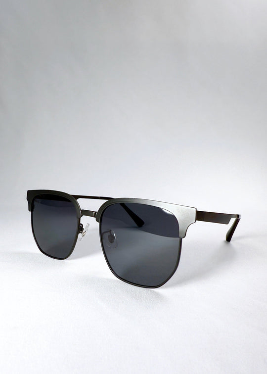 Angled front view of Altessa sunglasses in Eclipse Black, highlighting the matte-black finish and full-coverage grey lenses. 