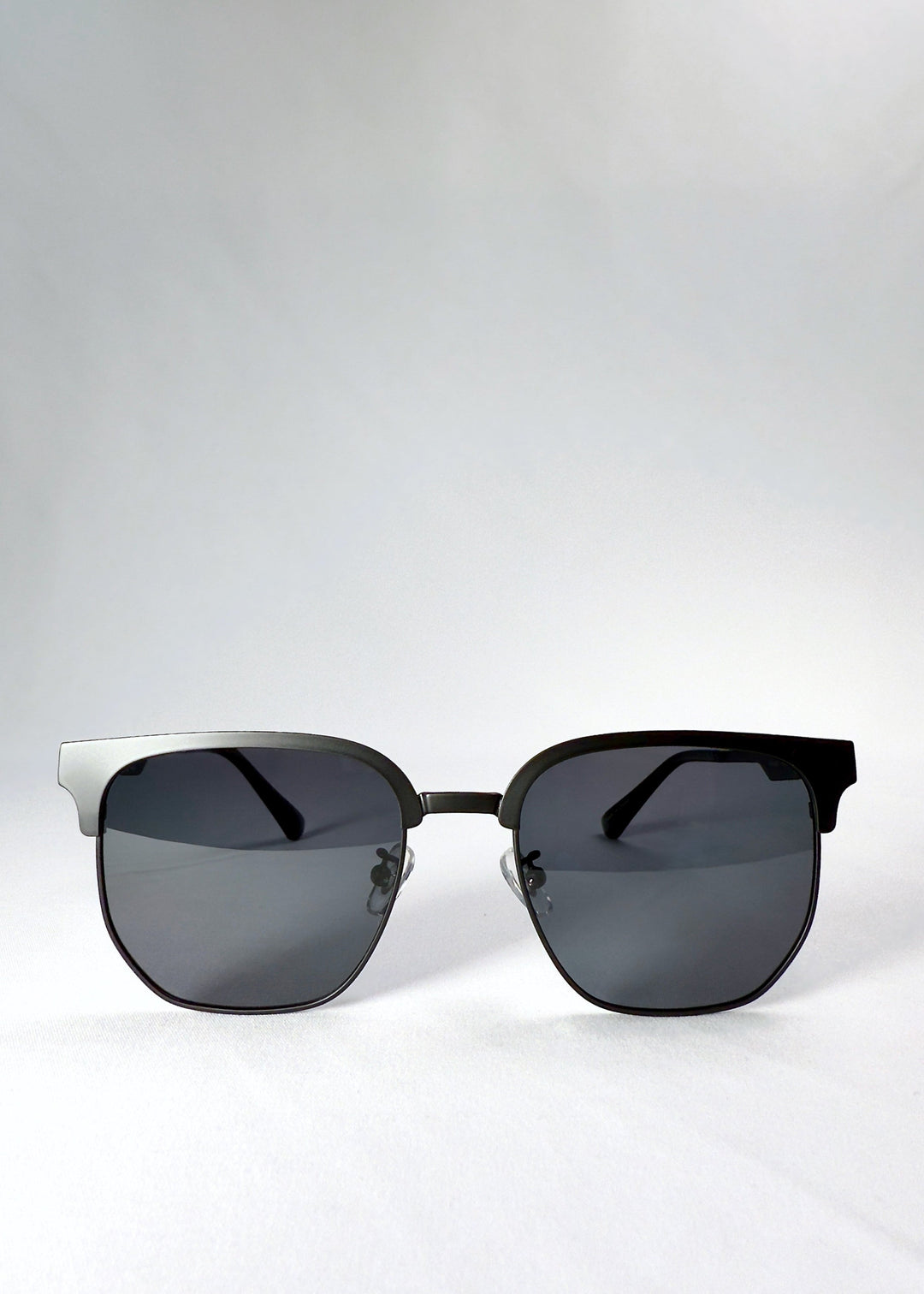 Front view of Altessa sunglasses in Eclipse Black, showcasing the bold browline silhouette and semi-rimless frame. 