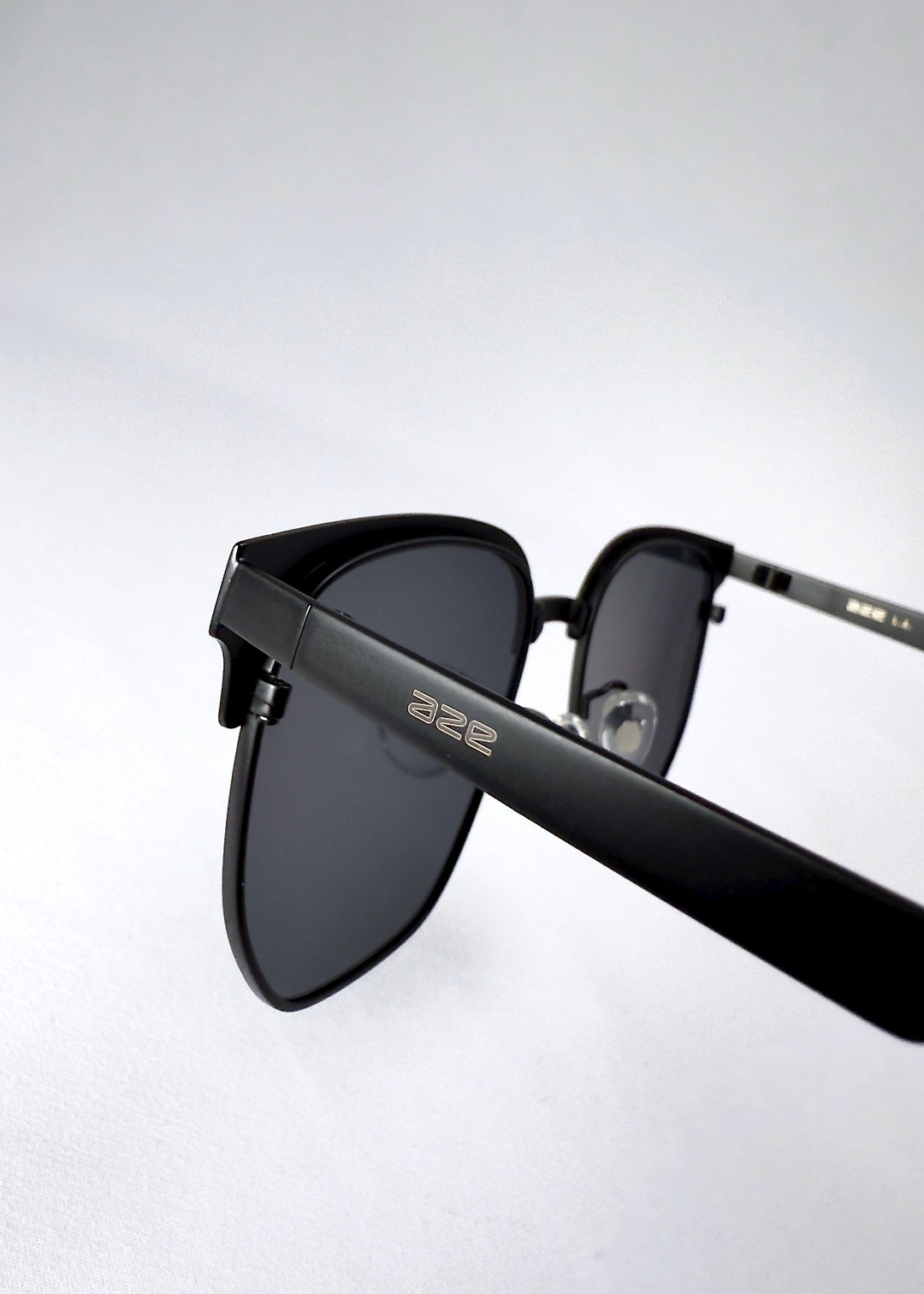 Close-up of the Altessa temple in Eclipse Black, featuring the subtle AZE logo and matte metal finish. 