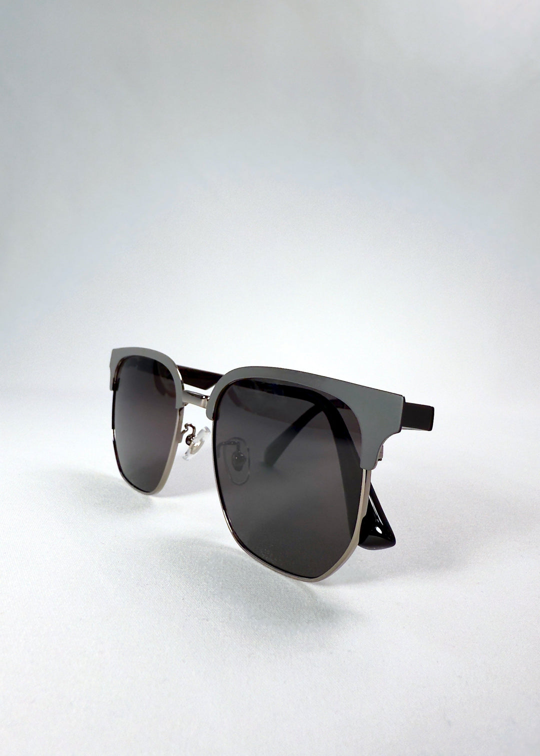 Folded view of Altessa Gunmetal Ash sunglasses emphasizing slim arms and dual-tone frame contrast. 
