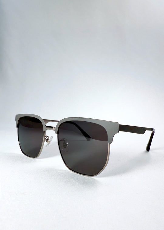 Three-quarter front angle of Altessa Gunmetal Ash sunglasses highlighting the geometric browline frame. 