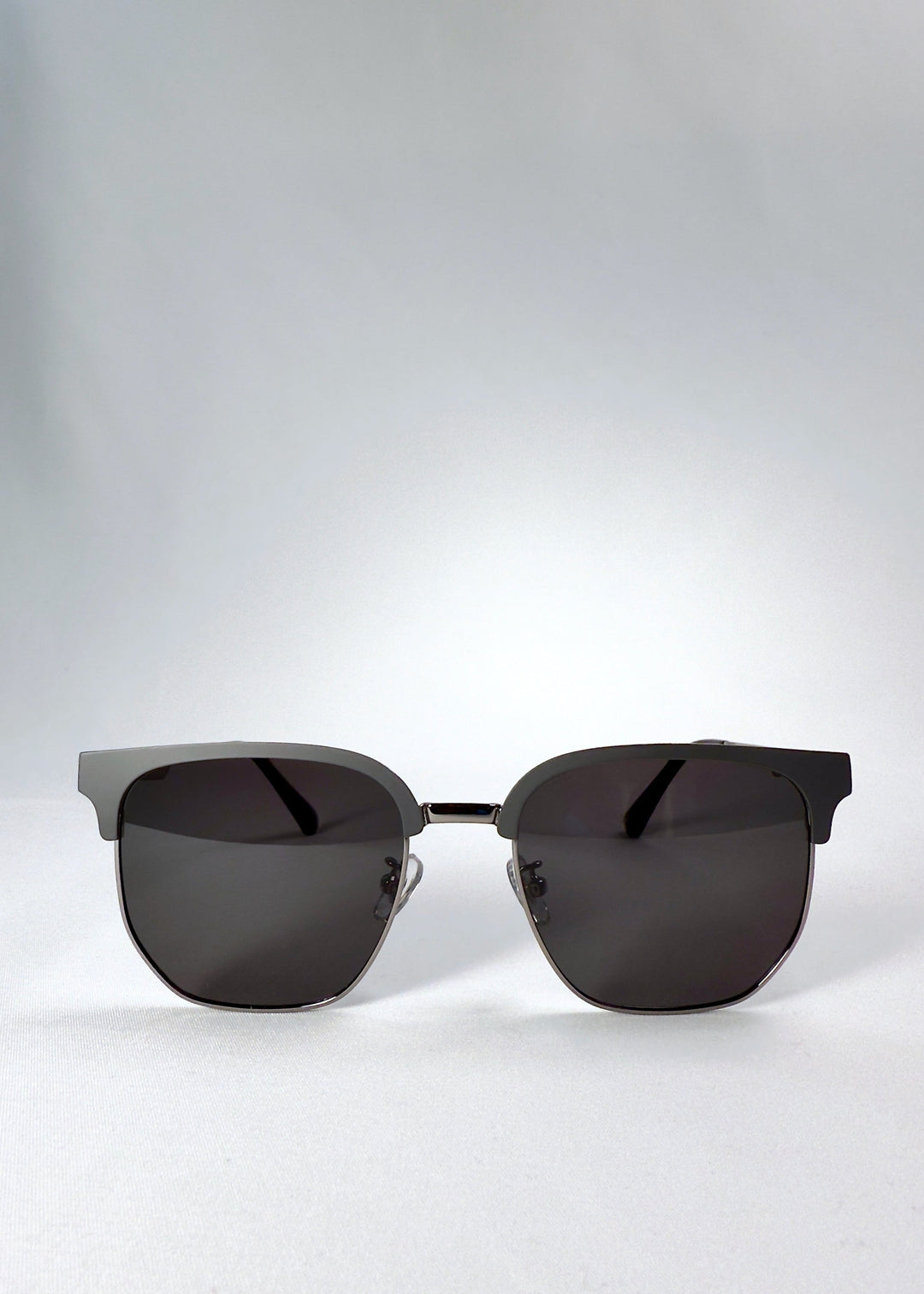 Front view of Altessa sunglasses in Gunmetal Ash, featuring a semi-rimless browline design and dark grey polarized lenses. 